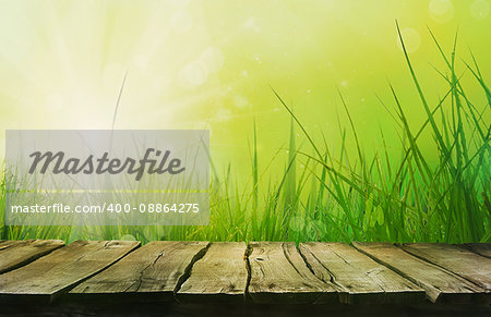 Spring grass. Blur background. Summer nature. Bokeh blurred background.Wooden table. Wood planks