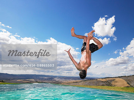 Man jumping in swimming pool