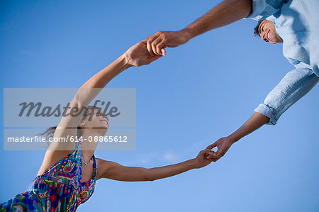 Loving couple hold hands