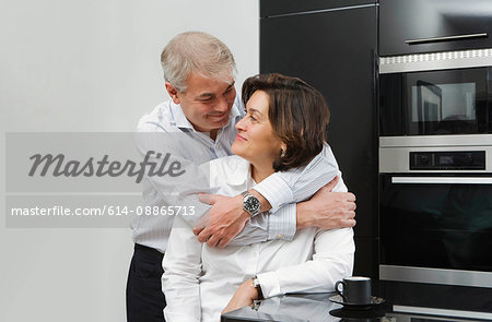 Mature man with arms around wife