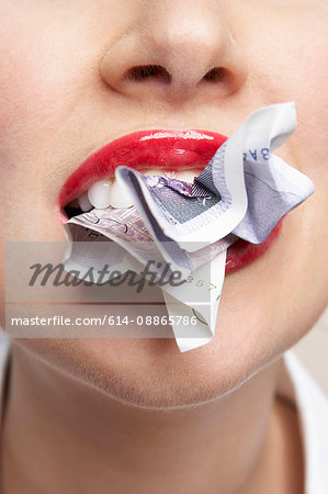 Woman eating a bank note