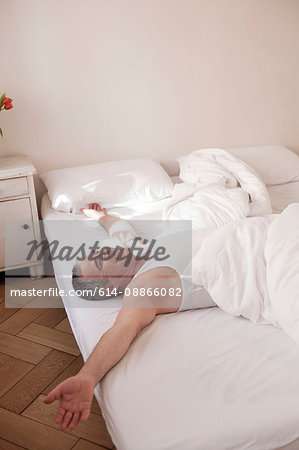 man lying on bed relaxing