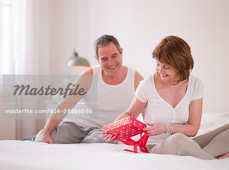 Eldery couple in bed with gifts