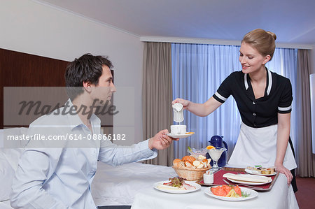 room maid serving businessman in his room