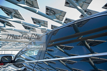 Solar panels reflected in car window