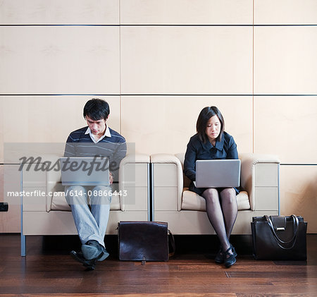 Man,woman working while waiting Man,woman working while waiting
