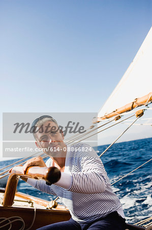 man steering a sailing boat