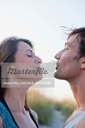 couple playing with bubble gum