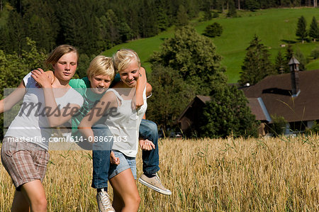 girls and boy walking along field