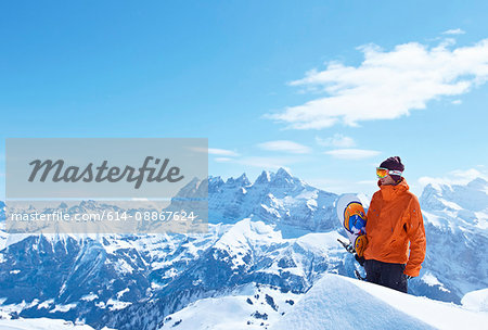 Male snowboarder in snowy mountains