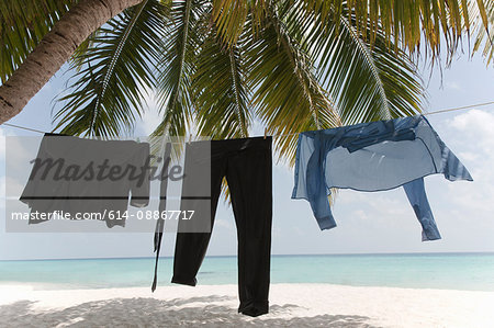 Business clothes drying on line on beach