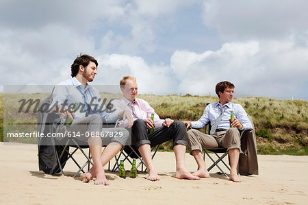 Businessmen relaxing on beach