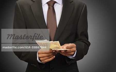 Businessman counting euros