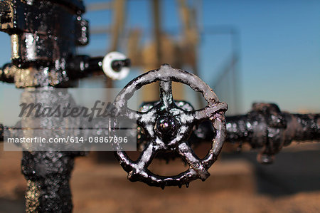 Close up of grimy wheel at oil field