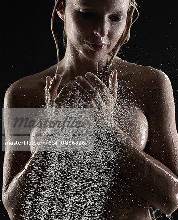 Woman splashing water on herself