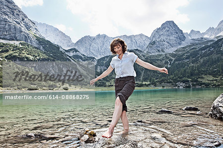 Woman in bare feet playing in lake