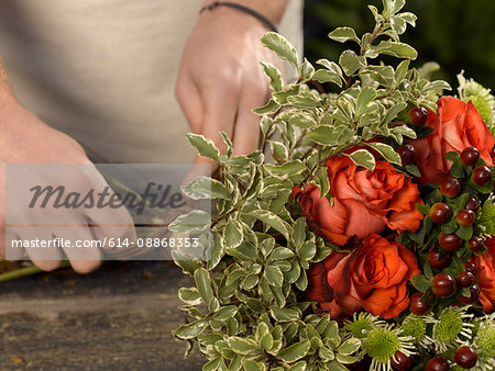 Florist tying bouquet in shop