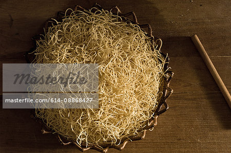 Basket of pasta dough on wooden board
