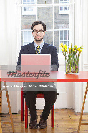 Businessman working on laptop at desk