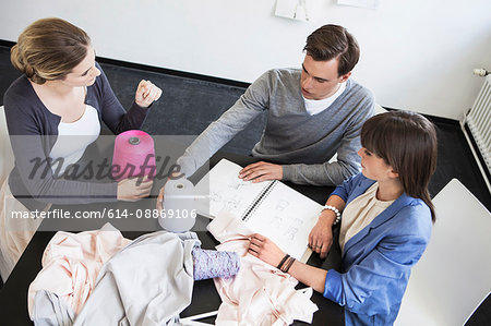 Business people examining fabric