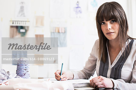 Businesswoman writing notes in office