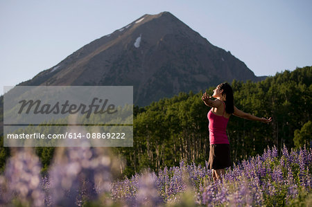 Woman standing in field of flowers