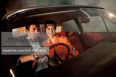 Couple driving together at night