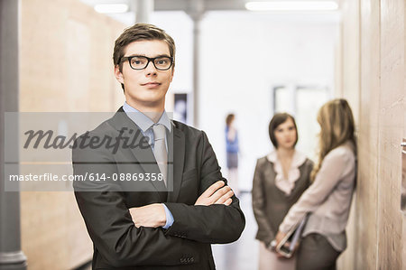 Businessman standing in hallway