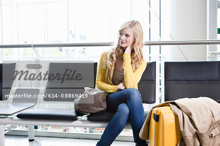 Woman sitting in airport waiting area