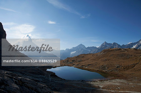 Aerial view of still lake in mountains