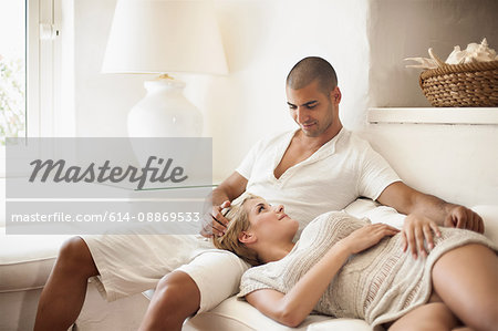 Couple relaxing on sofa in living room