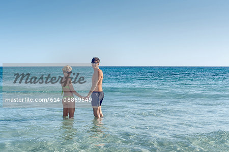 Couple standing in ocean together