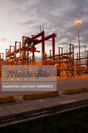 Cranes and ladders in shipyard at night