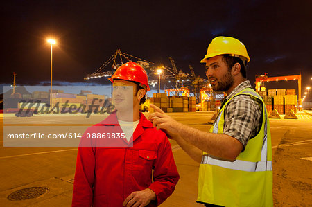 Workers talking in shipyard