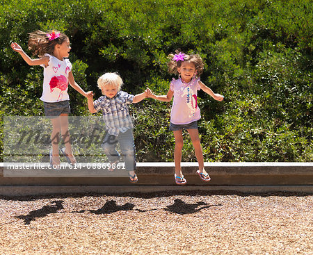 Children jumping together in park