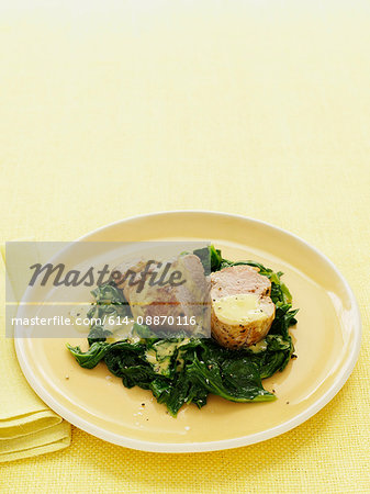 Plate of pork with mustard greens