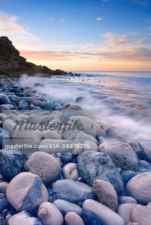 Waves washing up on rocky beach