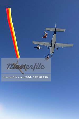 People skydiving from plane