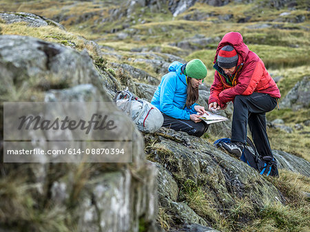 Hikers using map and compass