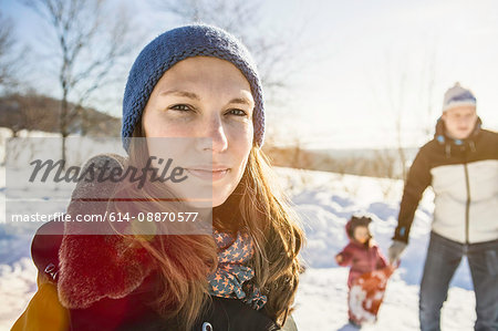 Woman walking with family in snow