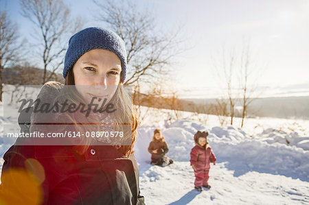 Woman walking with children in snow