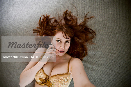 Woman in lingerie laying on floor