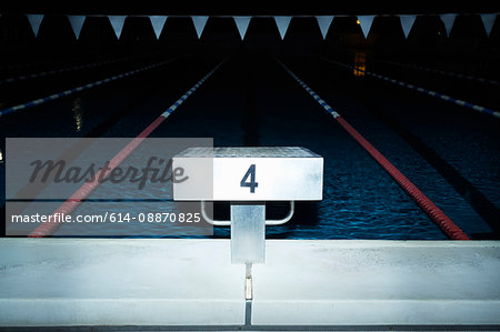 Springboard over lap pool at night