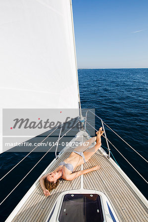 Woman sunbathing on boat