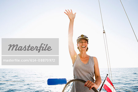 Smiling woman steering boat