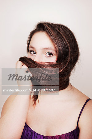 Teenage girl hiding her face with hair
