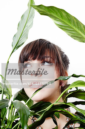 Portrait of a young woman in a plant