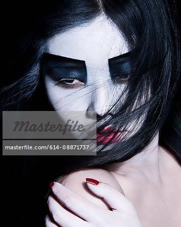 Young woman with dramatic makeup, black eyeshadow