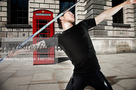 Javelin thrower with red telephone box in background