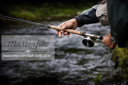 Casting fishing rod in Margaree River, Cape Breton Island, Nova Scotia